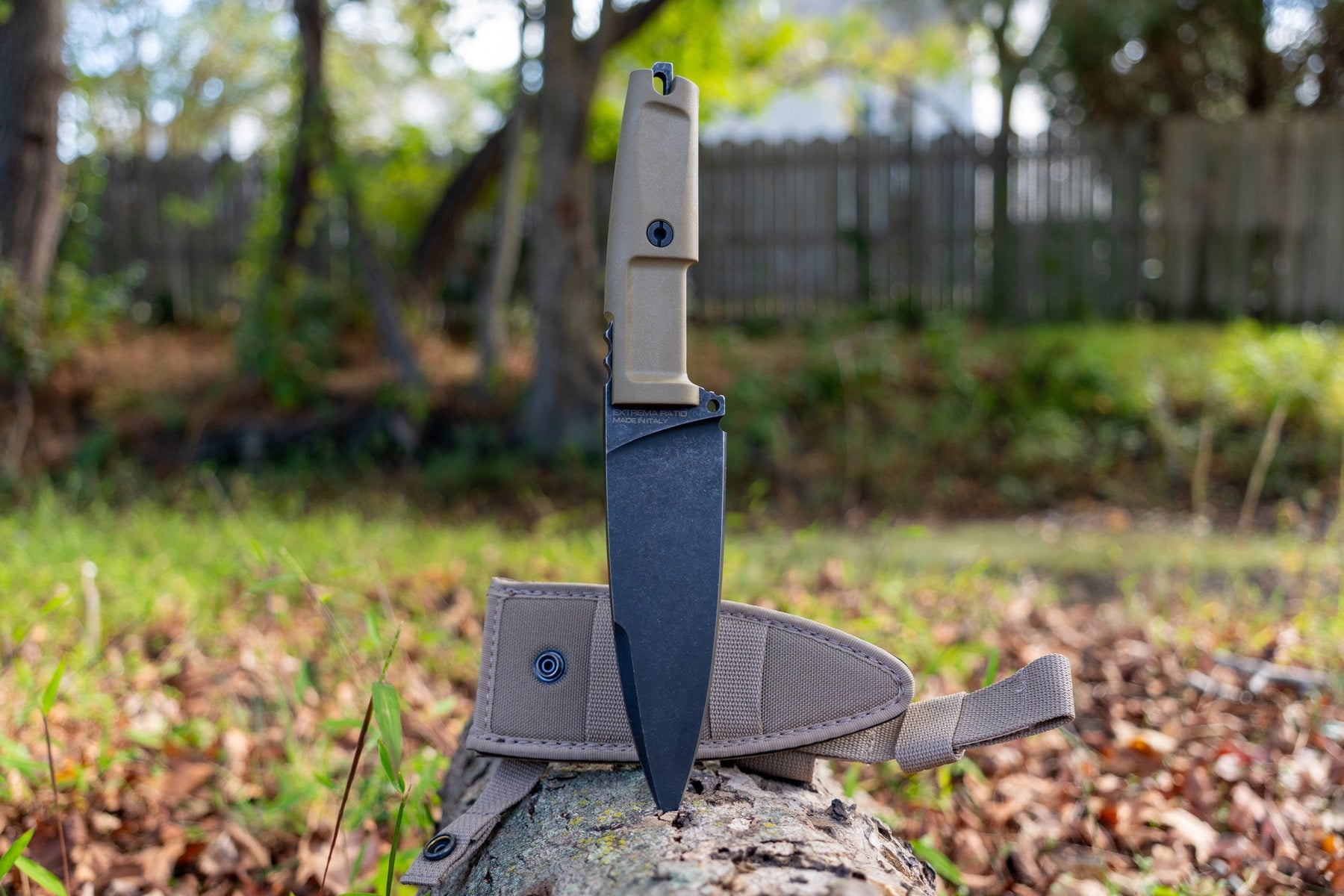 Full-length view of the Extrema Ratio Shrapnel One Desert Dark Stone beside its sheath